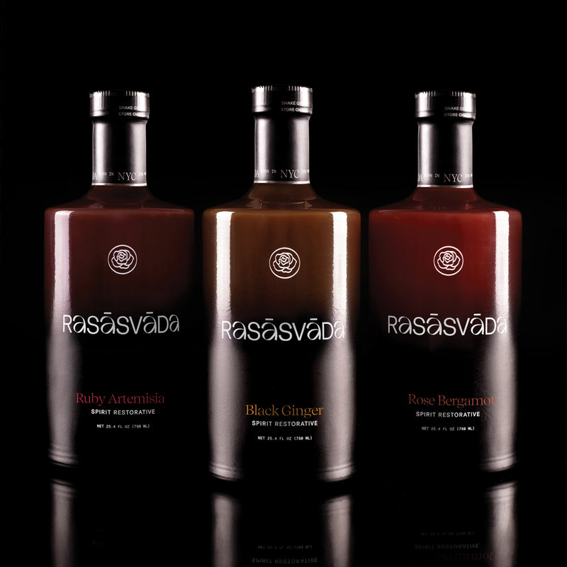 Three bottles of Rasšsvča bitters, each a different color, displayed side by side against a black background.