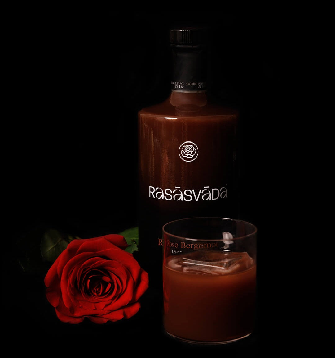 Bottle and glass of Rosasvada liqueur with a red rose on a black background